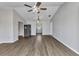 Spacious living room showcasing gray laminate flooring, a ceiling fan, and an open layout at 428 Briarwood Rd, Venice, FL 34293