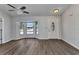 Inviting living room with wood floors, a ceiling fan, a bay window, and a white front door at 428 Briarwood Rd, Venice, FL 34293