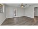 Bright living room with wood-look flooring, ceiling fan and view of pool area at 428 Briarwood Rd, Venice, FL 34293