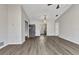 Open-concept living room with modern gray laminate flooring and abundant natural light at 428 Briarwood Rd, Venice, FL 34293