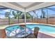Enclosed pool area with a glass table and chairs for outdoor entertainment at 428 Briarwood Rd, Venice, FL 34293
