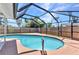 Enclosed pool with a dark frame surrounded by concrete at 428 Briarwood Rd, Venice, FL 34293