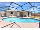 An enclosed in-ground pool surrounded by dark framing, and a covered patio at 428 Briarwood Rd, Venice, FL 34293