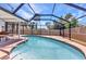 Pool surrounded by an dark frame and includes a table with seating at 428 Briarwood Rd, Venice, FL 34293