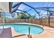 Pool with a dark frame and surrounded by concrete at 428 Briarwood Rd, Venice, FL 34293
