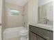 Bright bathroom featuring a tub, shower and granite vanity at 4336 Blackman St, North Port, FL 34291