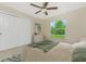 Bright bedroom featuring a ceiling fan, closet, and yard view at 4336 Blackman St, North Port, FL 34291