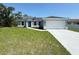 Charming single-story home featuring a well-manicured lawn, two car garage and pleasant landscaping at 4336 Blackman St, North Port, FL 34291