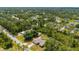 This aerial view showcases the property's sprawling lot and lush landscaping in a serene, tree-filled neighborhood at 4461 La France Ave, North Port, FL 34286