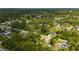 A lush, green neighborhood is shown in this aerial view of a charming single-story home with a spacious lot at 4461 La France Ave, North Port, FL 34286