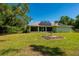 Large backyard with solar panels, screened in porch, and grass perfect for entertaining or relaxing at 4461 La France Ave, North Port, FL 34286