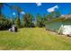Vast backyard with the well system on the left and a home featuring solar panels at 4461 La France Ave, North Port, FL 34286