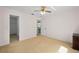 Spacious bedroom with a ceiling fan, closet, and neutral carpet at 4461 La France Ave, North Port, FL 34286