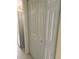 A storage closet with bi-fold doors is conveniently located by the stainless steel refrigerator in the kitchen at 4461 La France Ave, North Port, FL 34286