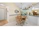 Charming dining area featuring a round table, four chairs, and access to kitchen at 4461 La France Ave, North Port, FL 34286