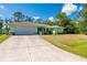 Charming single-story home with a large driveway and well-maintained lawn at 4461 La France Ave, North Port, FL 34286
