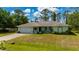 A cozy single-story home with a two-car garage and a meticulously manicured lawn creates a welcoming curb appeal at 4461 La France Ave, North Port, FL 34286