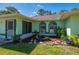 Close-up of the front of the house, showing the landscaping and greenery with a small pond at 4461 La France Ave, North Port, FL 34286
