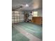 View of garage with open door and storage area; ample space for vehicles and projects at 4461 La France Ave, North Port, FL 34286