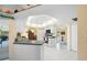 Bright kitchen features white cabinets, countertops, and access to the dining room at 4461 La France Ave, North Port, FL 34286