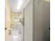 Laundry room featuring white appliances, tile floors, and a bright window at 4461 La France Ave, North Port, FL 34286