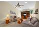 Cozy living room with ceiling fan, plush sofas, and built-in entertainment center at 4461 La France Ave, North Port, FL 34286
