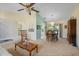 Bright living room with ceiling fan, dining area, and sliding glass doors to the exterior at 4461 La France Ave, North Port, FL 34286