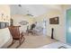 Bright living room featuring vaulted ceilings, neutral walls, carpeting, and classic furniture at 4461 La France Ave, North Port, FL 34286