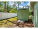 Green storage shed located in the back yard, ideal for storing lawn care and gardening equipment at 4461 La France Ave, North Port, FL 34286