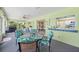 Enclosed sunroom with lots of light and view of the backyard, along with a table and chairs at 4461 La France Ave, North Port, FL 34286