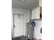 Utility room with hot water tank and storage at 4461 La France Ave, North Port, FL 34286
