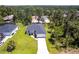 Aerial view of the house surrounded by mature trees, showcasing its serene and private location at 4880 Cornsilk Ter, North Port, FL 34286