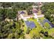An aerial view showcases the property's location within a lush, wooded neighborhood at 4880 Cornsilk Ter, North Port, FL 34286