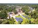 An aerial view showcases the property's location within a lush, wooded neighborhood at 4880 Cornsilk Ter, North Port, FL 34286