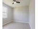 Bright bedroom features light-colored flooring, a large window, and neutral walls at 4880 Cornsilk Ter, North Port, FL 34286