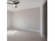 This bedroom features light-colored flooring, neutral walls and a ceiling fan at 4880 Cornsilk Ter, North Port, FL 34286