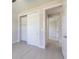 Bedroom features closet with sliding doors and light-colored flooring at 4880 Cornsilk Ter, North Port, FL 34286