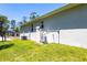 Side exterior of a single-Gathering home showing modern utilities and a well-kept lawn at 4880 Cornsilk Ter, North Port, FL 34286