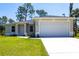 Charming single-story home with a well-maintained lawn, driveway, and attached garage at 4880 Cornsilk Ter, North Port, FL 34286