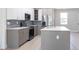 Spacious kitchen with a center island, stainless steel appliances, and modern backsplash at 4880 Cornsilk Ter, North Port, FL 34286