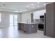 Modern kitchen featuring stainless steel appliances, a large island, and sleek cabinetry at 4880 Cornsilk Ter, North Port, FL 34286