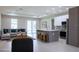 Open-concept living room and kitchen with modern finishes and plenty of natural light at 4880 Cornsilk Ter, North Port, FL 34286