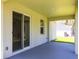 Covered patio featuring sliding glass doors and neutral paint with an additional window at 4880 Cornsilk Ter, North Port, FL 34286