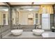 Bright bathroom featuring double sinks, illuminated mirror, and updated fixtures at 58 Lakeview Dr, North Port, FL 34287