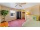Cozy bedroom with large window, ceiling fan, and closet at 58 Lakeview Dr, North Port, FL 34287