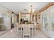 Bright dining room featuring a chandelier, stylish furniture, and sliding glass doors at 58 Lakeview Dr, North Port, FL 34287