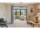 View of enclosed patio from living room with glass sliding doors. Tile flooring and comfortable seating at 58 Lakeview Dr, North Port, FL 34287
