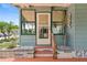 Close-up of a charming entryway with a screen door, stylish steps, and decorative plants at 58 Lakeview Dr, North Port, FL 34287