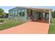 Inviting home showcasing a covered porch, vibrant painted driveway, and well-kept landscaping at 58 Lakeview Dr, North Port, FL 34287