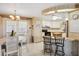 Open kitchen boasts a breakfast bar, white cabinetry, and door leading outside at 58 Lakeview Dr, North Port, FL 34287